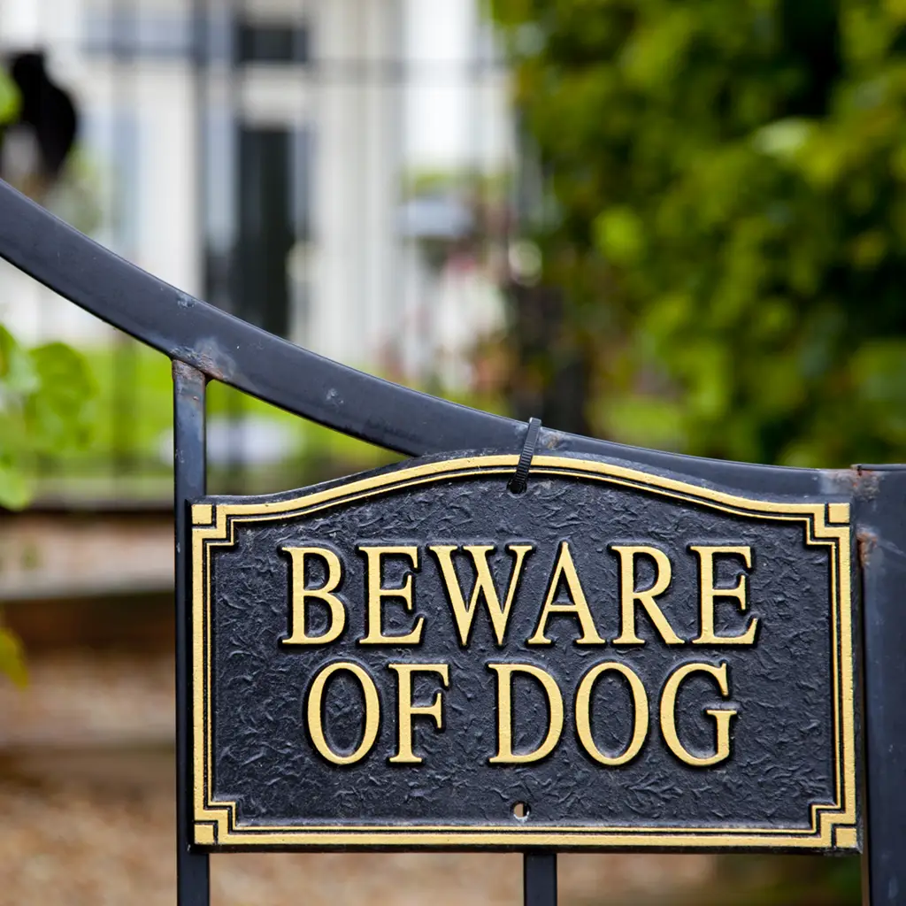 beware of dog sign on gate of home